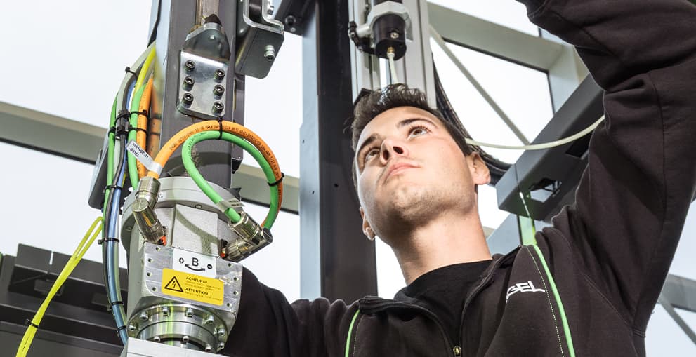 Technician working on injection moulding machinery